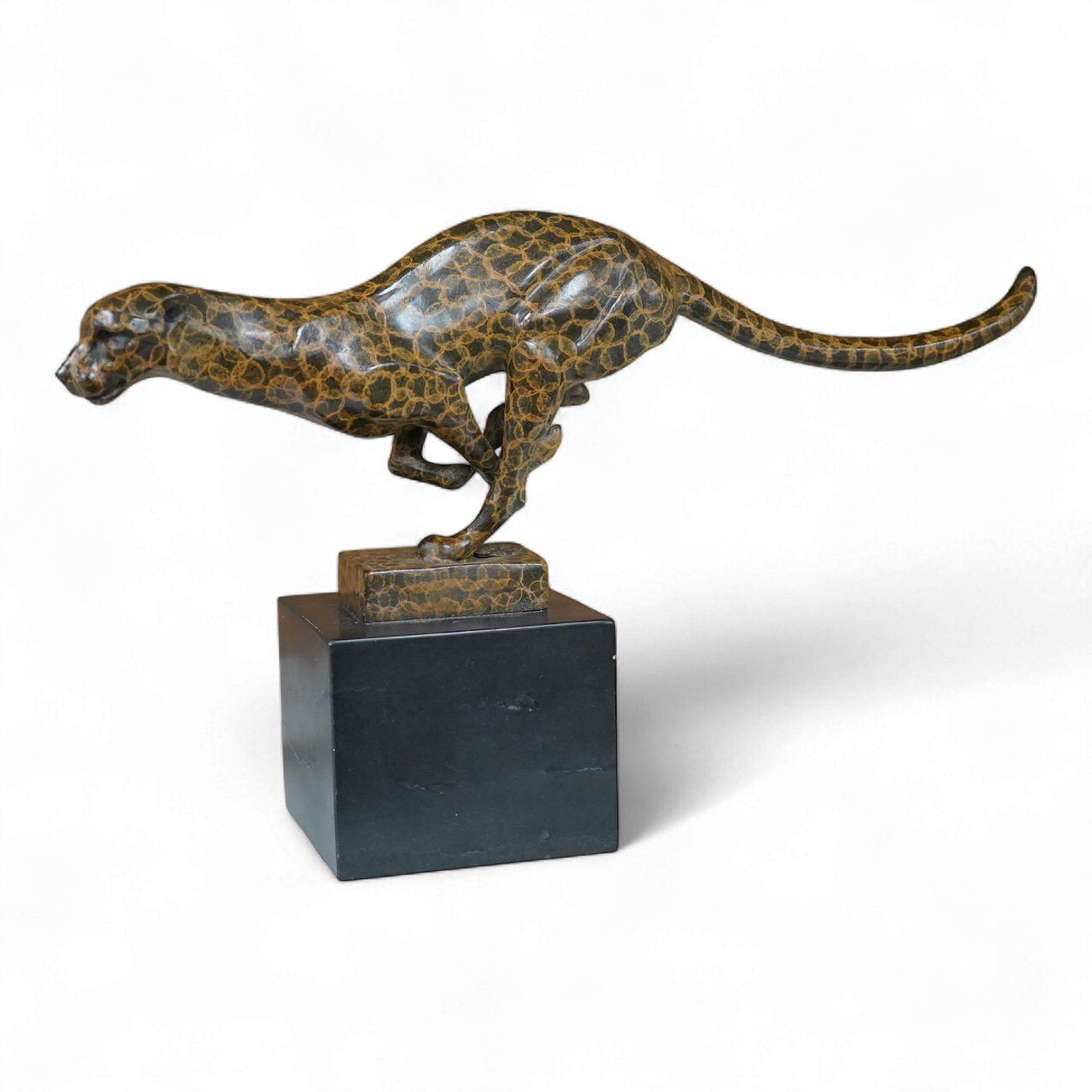 A patinated bronze cheetah bearing J.B. Depose foundry stamp, on slate plinth, 19cm high